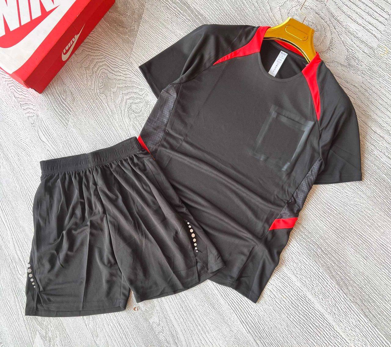 A black sports jersey and shorts set with red trim, unbranded and ready for team logos