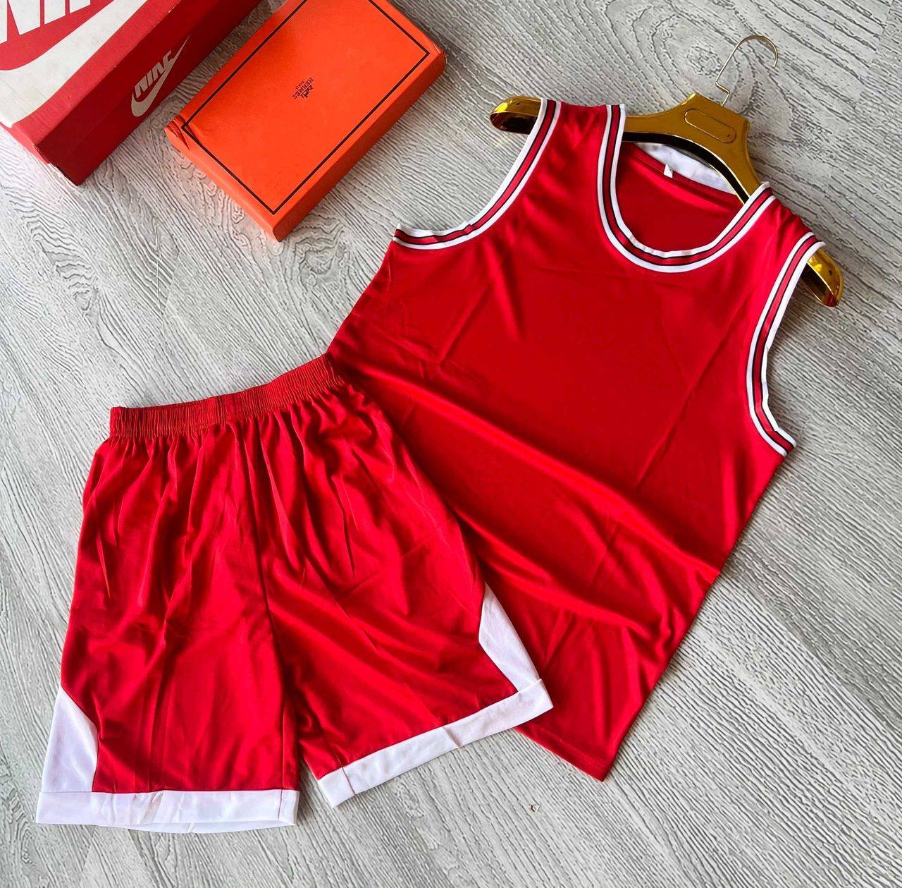 A red sleeveless sports jersey and shorts set with white trim, unbranded and ready for team logos